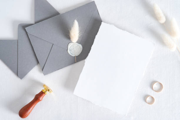 istock Wedding invitation card mockup, grey envelopes, rings on white background. Flat lay, top view. Minimal style. 1325588234