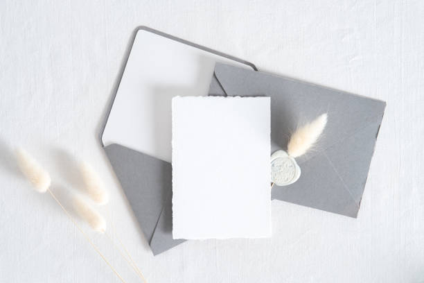 istock Wedding invitation card template. Top view blank paper card, grey envelopes, dried flowers on white background. 1325588242