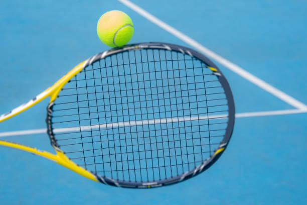 istock tennis ball detail on racket 1325588910