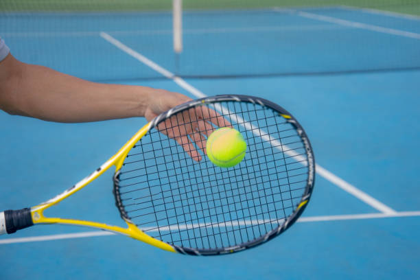 istock tennis ball detail on racket 1325588915