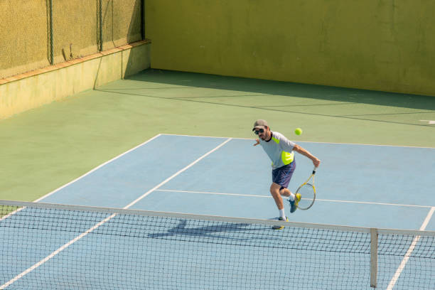istock man playing tennis 1325588956