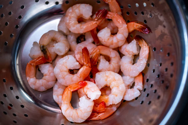 istock Top down view of king prawns being washed 1325590810