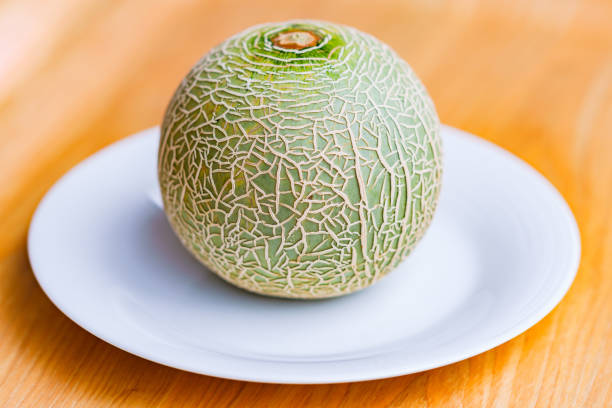 selected focus of A fresh green Melon on wooden background