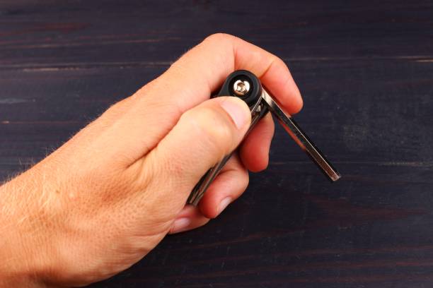 istock Bicycle key in hands on dark background closeup 1325592034