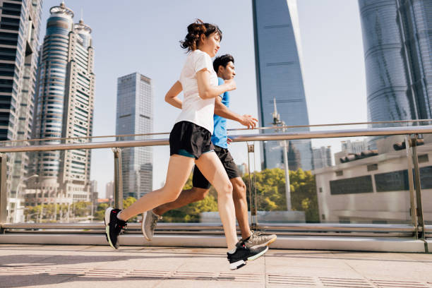 istock Couple running in city. 1325593906