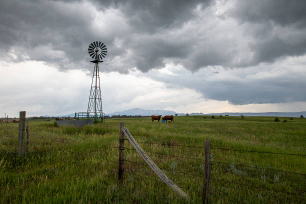 Working windmill with wild thunderstorm and hail nearby. This is Colorado prairie northeast of Monument, Colorado in western USA. Nearest larger town is Colorado Springs, Colorado. Hail was falling heavily just 1/4 mile ahead. John Morrison - Photographer