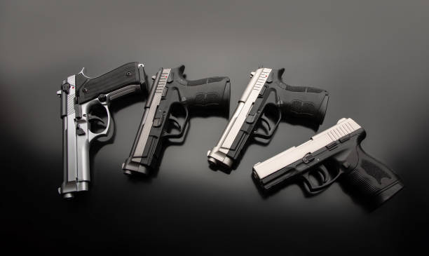 istock Black modern pistols on a dark background. A short-barreled weapon for concealed carry. Armament of the police, army and special units. 1325596109