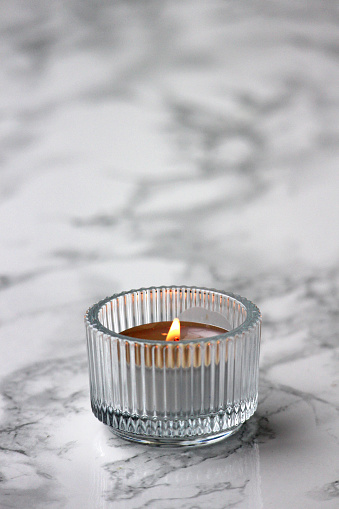 A low burning small candle in a tealight holder.