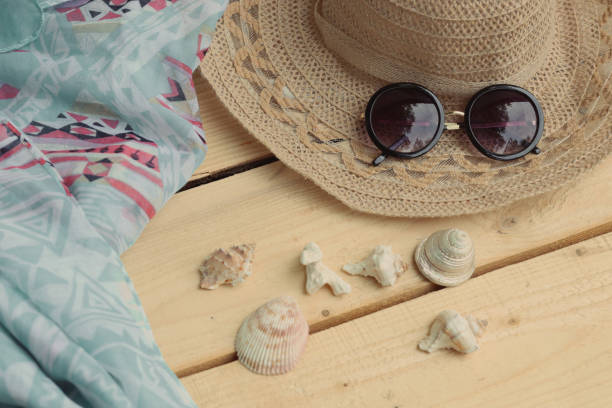 istock Hat and sunglasses, scarf and shells. Summer themes, vacations 1325600927