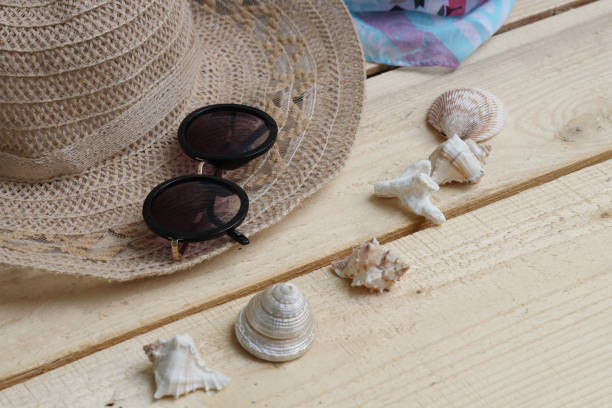 istock Hat and sunglasses, scarf and shells. Summer themes, vacations 1325600941