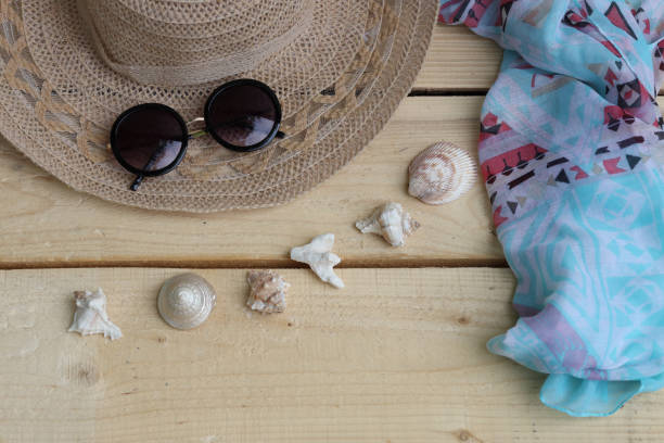 istock Hat and sunglasses, scarf and shells. Summer themes, vacations 1325600946