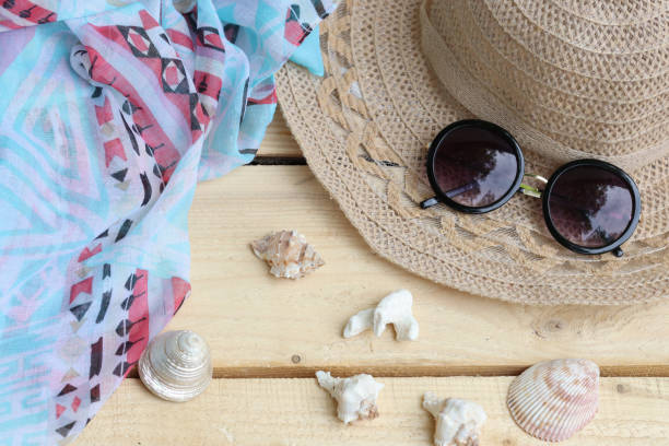 istock Hat and sunglasses, scarf and shells. Summer themes, vacations 1325600976