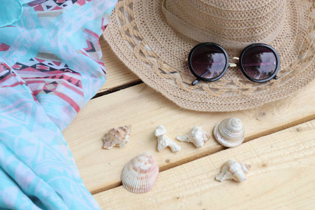 istock Hat and sunglasses, scarf and shells. Summer themes, vacations 1325600984