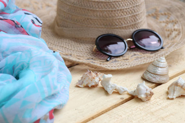 istock Hat and sunglasses, scarf and shells. Summer themes, vacations 1325600986