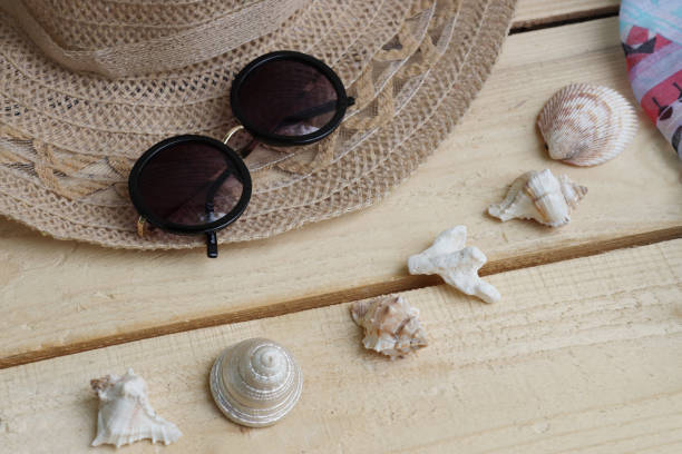 istock Hat and sunglasses, scarf and shells. Summer themes, vacations 1325600987