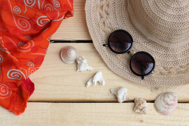 istock Hat and sunglasses, scarf and shells. Summer themes, vacations 1325600990