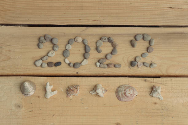 istock 2022 logo lined with sea stones and blue cornflowers 2022 1325601009