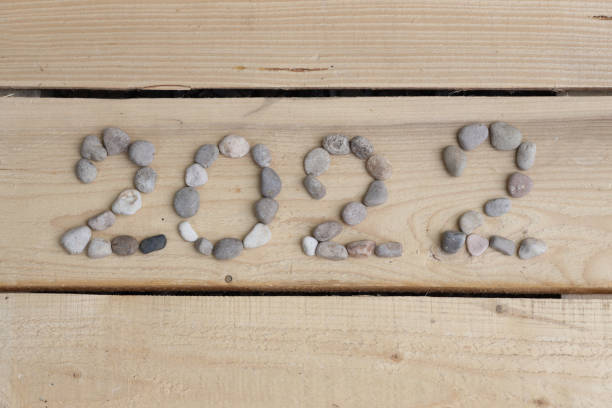 istock 2022 logo lined with sea stones and blue cornflowers 2022 1325601037