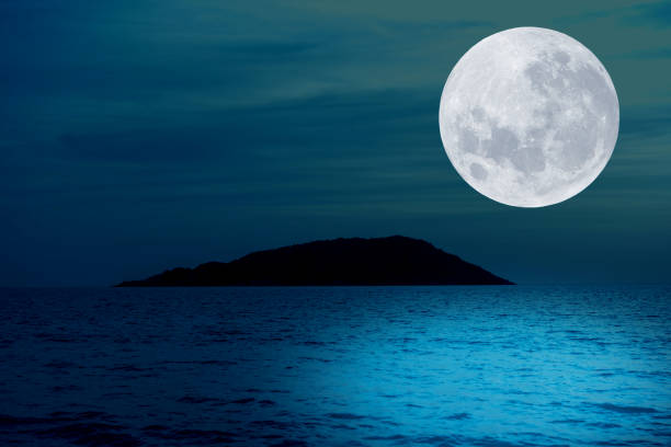 istock Full moon on sky over sea in the night. 1325601248