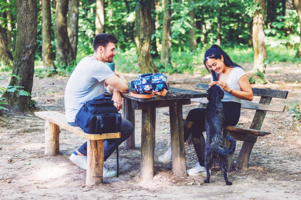 istock Couple with their playful pet taking a break during hike 1325601422