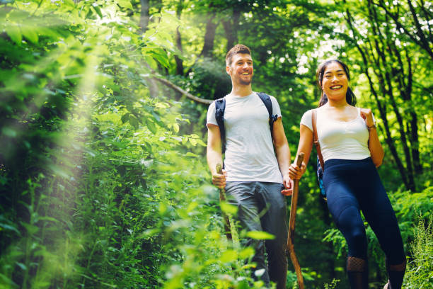 istock Couple Enjoying the Forest Hiking Experience 1325603309