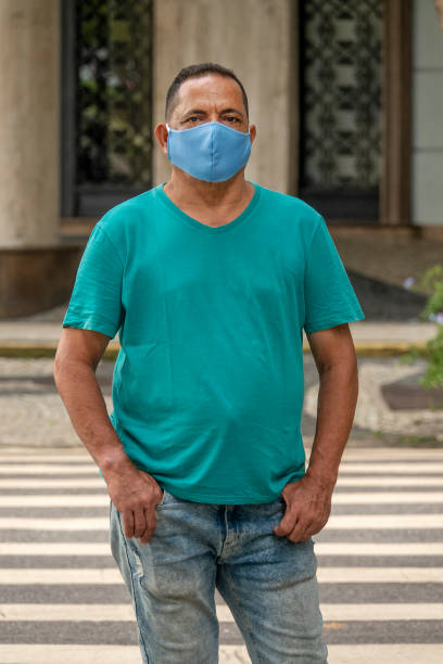 istock Man standing looking at camera during pandemic 1325604363