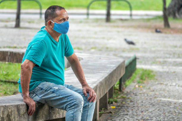 istock Man sitting in a square during the pandemic 1325604409