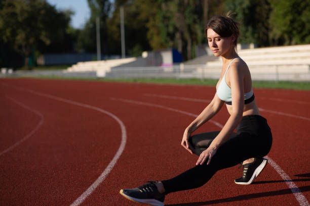 istock Sporty model warms up before running 1325610724