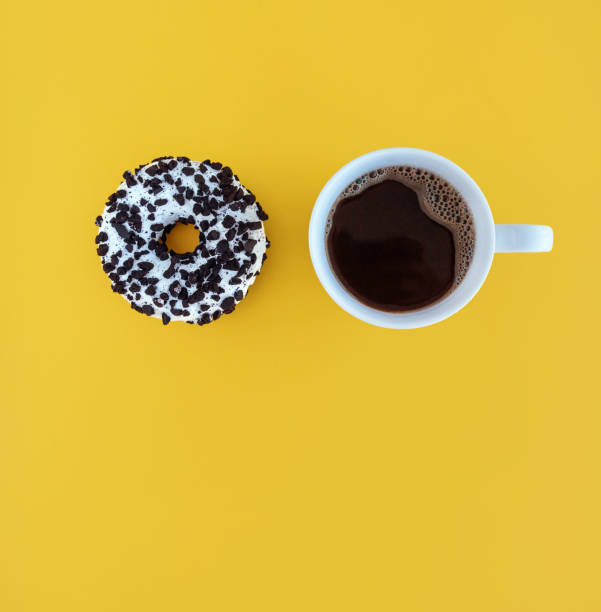 istock donut and coffee cup on yellow background breakfast sweets 1325617779