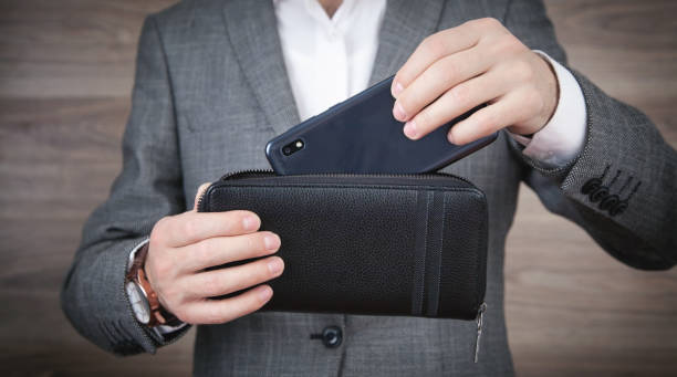 istock Man showing smartphone and wallet. 1325618011