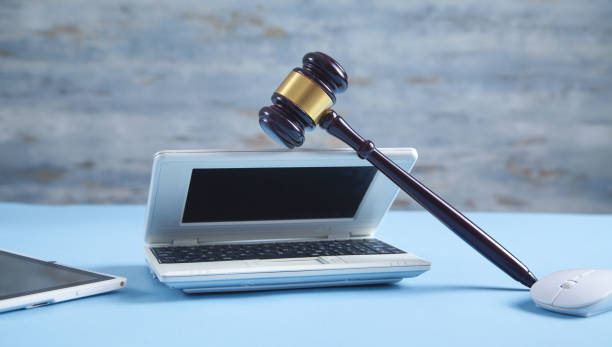 istock Judge gavel with a computer mouse and laptop. 1325618047