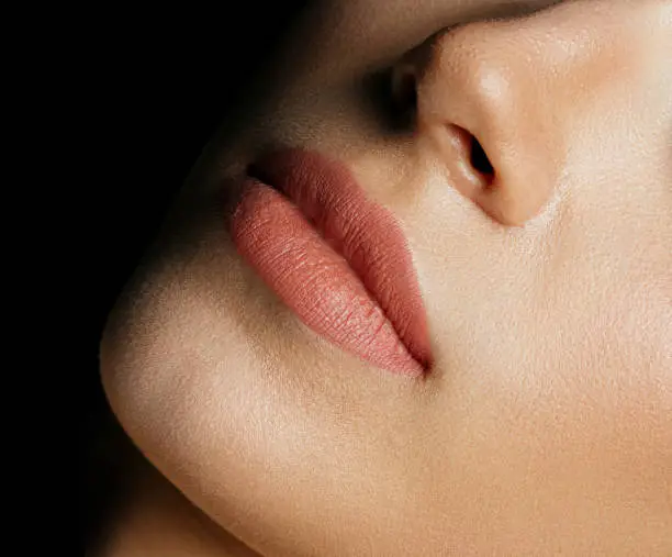 Closeup photo of perfect woman's lips after permanent makeup procedure. Space for text