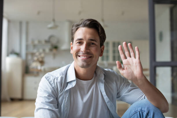 istock Man using video chat meeting with friends online 1325620068