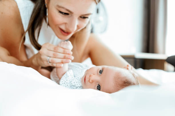 istock Mother and baby playing in the bed 1325621287