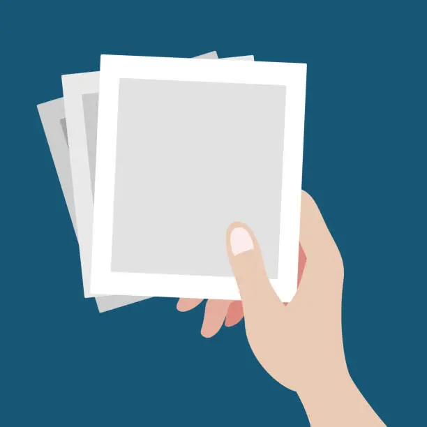 Vector illustration of A beautiful hand grabbing three of blank polaroid pictures template flat vector illustration. Set of pictures in one hand reminds lots of memories isolated background.