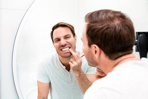 istock Young man brushing teeth in the bathroom 1325623891