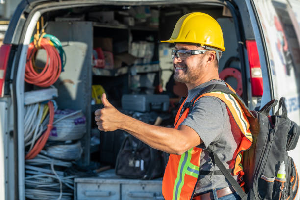 istock Smiling hispanic construction worker wearing a work helmet looking away with his thumbs up 1325624097