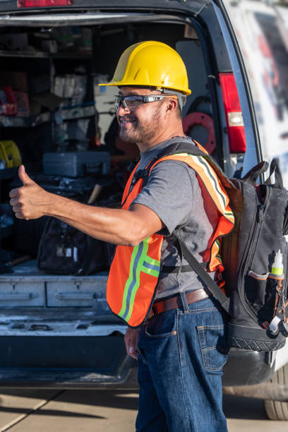 istock Smiling hispanic construction worker wearing a work helmet looking away with his thumbs up 1325624371