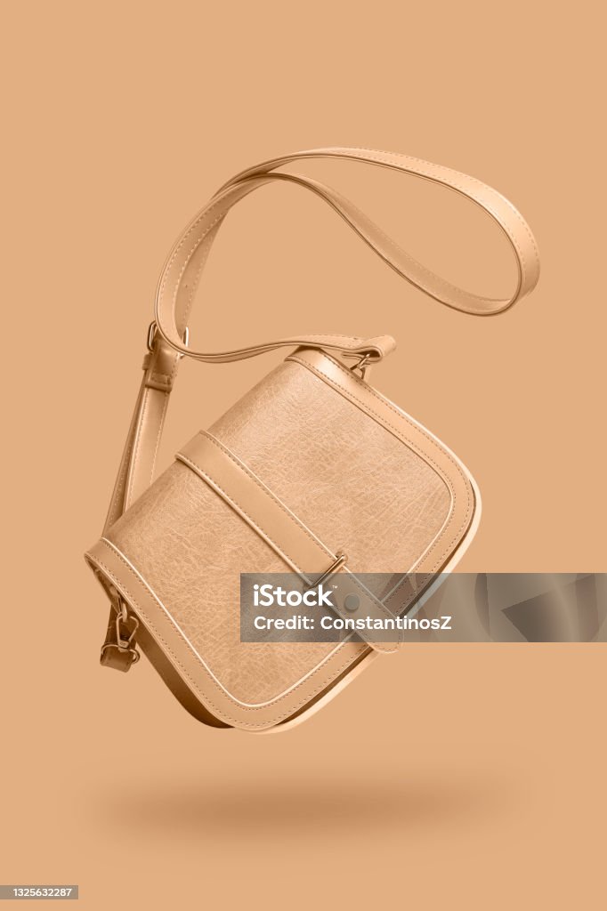 women's floating leather bag women's leather bag isolated on same colored background Purse Stock Photo