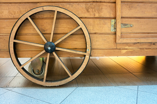 Isolated objects: one very old wooden waggon wheel on white background