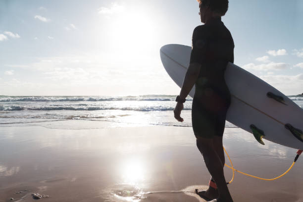 istock African malagasy young surfer watching waves at the beach shore 1325633401