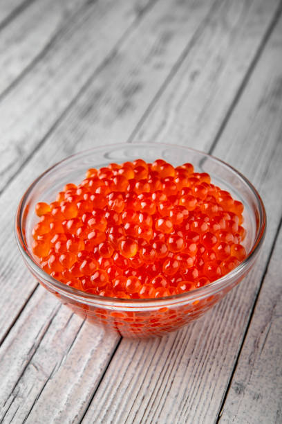 red caviar in a crystal bowl on a white background. delicacy product - salt crystal spoon food imagens e fotografias de stock