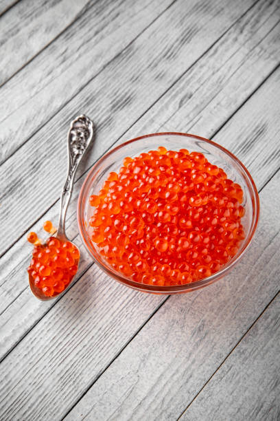 red caviar in a crystal bowl on a white background. delicacy product - salt crystal spoon food imagens e fotografias de stock