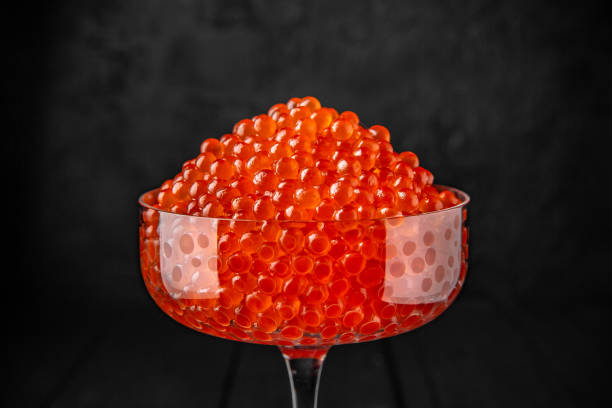 red caviar in a crystal bowl on a black background. delicacy product - salt crystal spoon food imagens e fotografias de stock