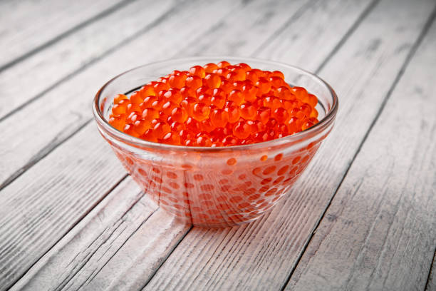 red caviar in a crystal bowl on a white background. delicacy product - salt crystal spoon food imagens e fotografias de stock