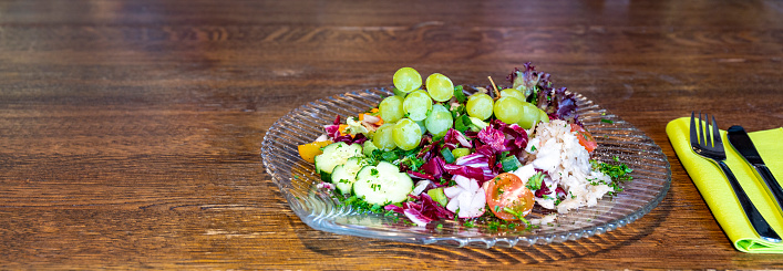 View of a Plate Mixed fresh salad with grapes and honey dressing for gastronomy or restaurant Copy space