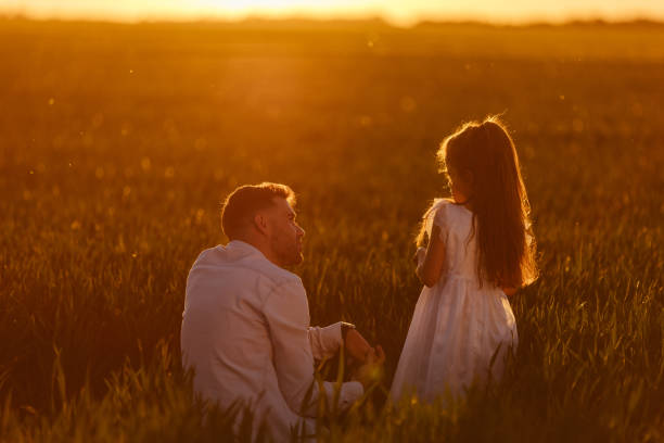 istock Young father in sunny nature with his cute small daughter 1325645375