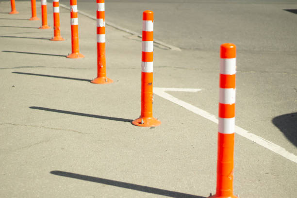 istock Parking stops. Orange posts in the parking lot. 1325646206