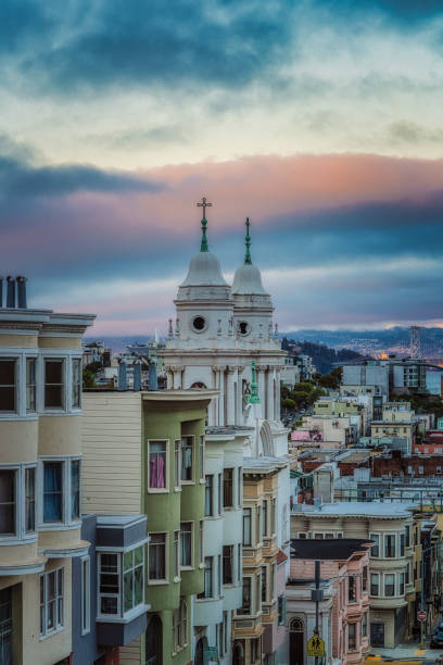San Francisco skyline with a colorful sunset  at dusk. Church spires against the sunset sky.