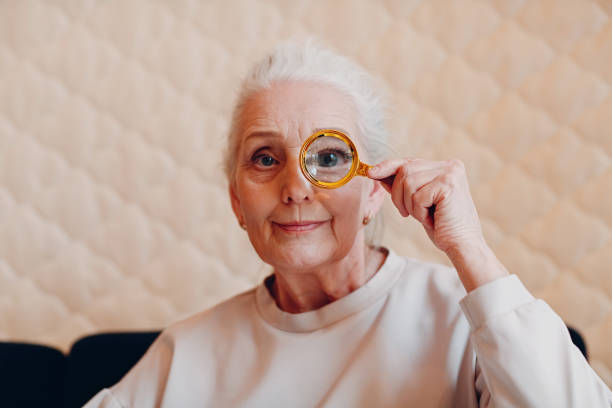 istock The elderly woman with magnifier loupe in hand 1325652521